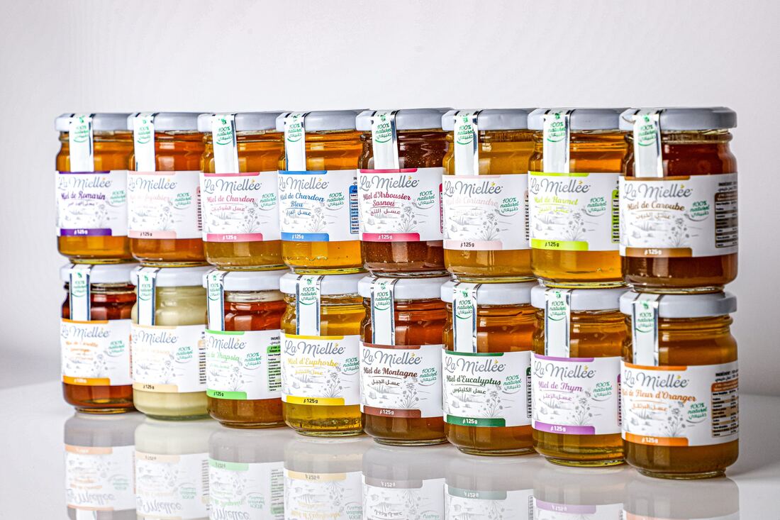 Une vingtaine de pots La Miellée de variétés différentes alignés sur deux rangs